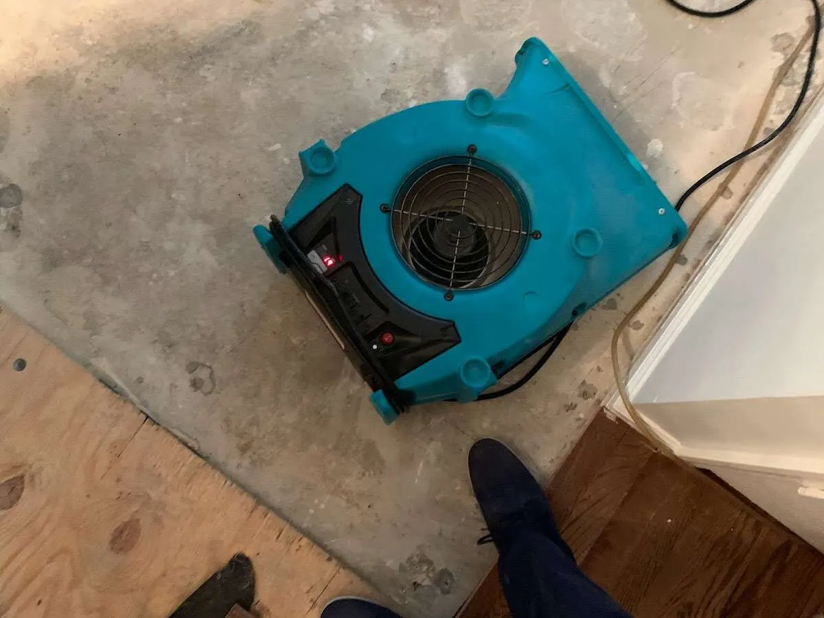 Air mover drying subfloor during Leak Detection & Repair in West Monroe
